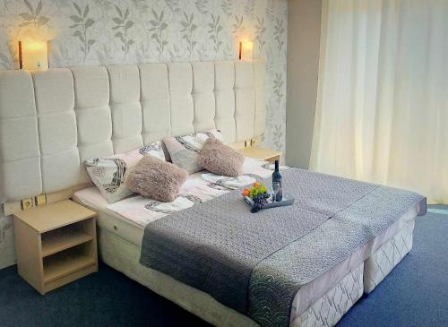 a bedroom with a large bed with a white headboard at Sunrise Studio Grenada in Sunny Beach