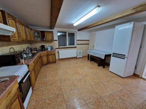 a kitchen with a white refrigerator and a table at Cabana Muntelui in Cluj-Napoca