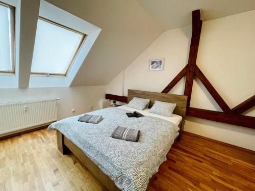 a bedroom with a large bed in a attic at Central Apartment Fun & Teambuilding in Košice