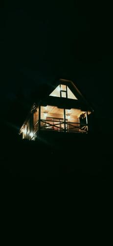 a small house with a light in the dark at Brvnara Tarska Zora in Sekulić 