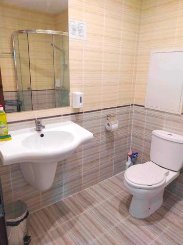 a bathroom with a toilet and a sink at Sunrise Studio Grenada in Sunny Beach