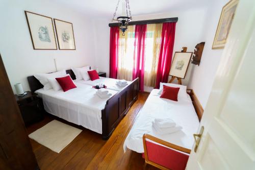 a bedroom with two beds with red pillows at Wind & Water in Delnice