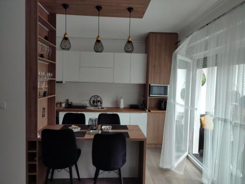 a kitchen with a table and chairs in a room at La Vista in Stari Banovci