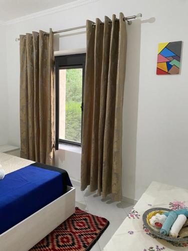 a bedroom with a bed and a window at Villa Meta - Welcoming You with Byrek & Traditional Meals in Gusmar