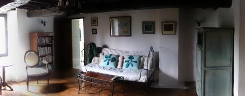 a living room with a couch with blue pillows at Quaint and original loft room 