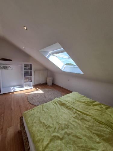 um quarto com uma cama grande e uma clarabóia em Ferienwohnung mit Weitblick in Nordhessen em Gudensberg