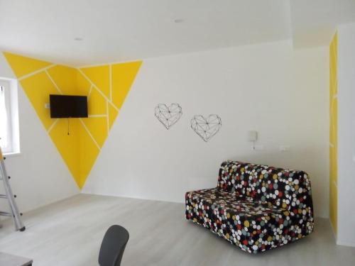 a chair in a room with hearts on the wall at La Casa sul Lago Apartments - Lemon Tree Apartment in Limone sul Garda