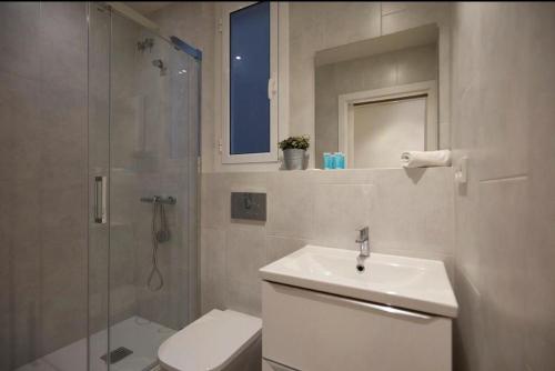 a bathroom with a toilet and a sink and a shower at H&S Rural in Peterborough