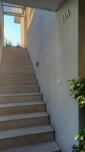 a set of stairs in a building with the number at Appartamento A in Gradara