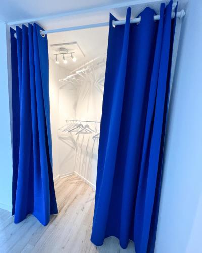 a pair of blue curtains in a room at Home Inn Apartments - 201 in Minden