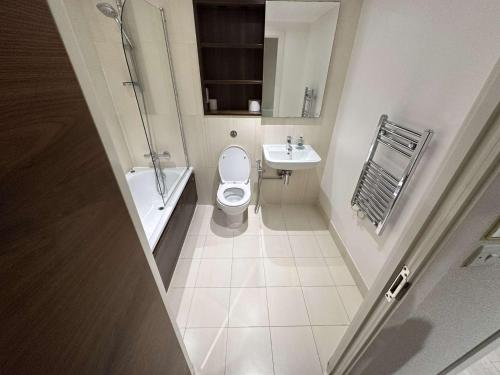 a bathroom with a toilet and a sink at Tidy west London getaway in London