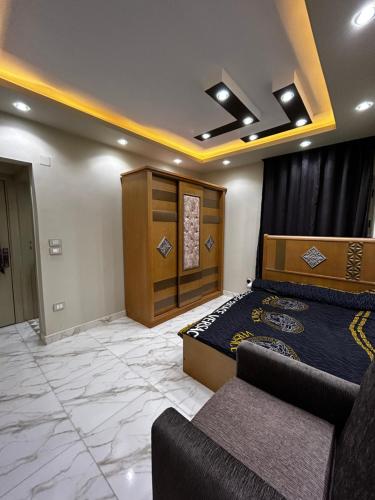 um quarto com uma cama e um sofá num quarto em شاليه فندقي بقرية بدر بالساحل الشمالي em El Alamein