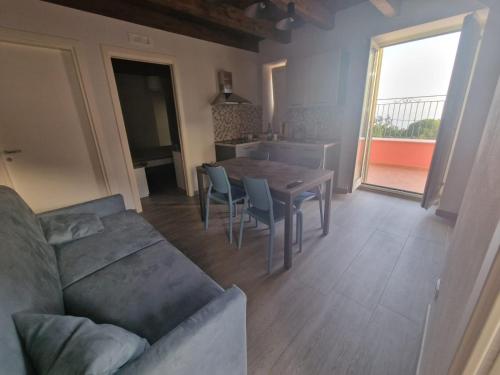 uma sala de estar com um sofá e uma mesa em Residence Mirella em Acquafredda