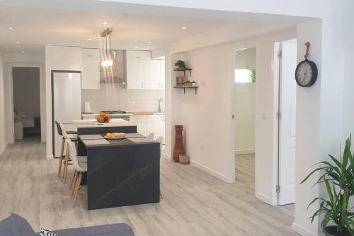 d'une cuisine et d'un salon avec une table et une horloge. dans l'établissement Elda, Alicante, à Elda