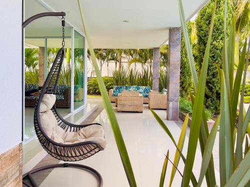 a swing in the living room of a house at Lago Calima Bliss: Secret Garden Paradise in Darien in Darién