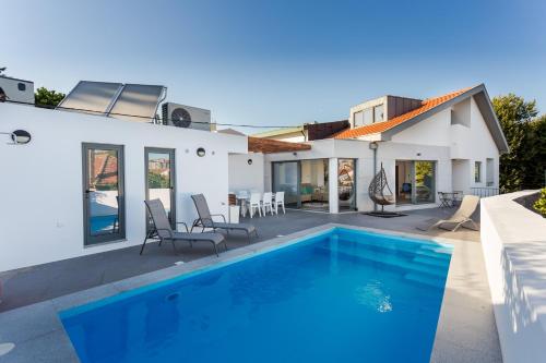 a swimming pool in the backyard of a house at Romantic Pool House in Vila do Conde