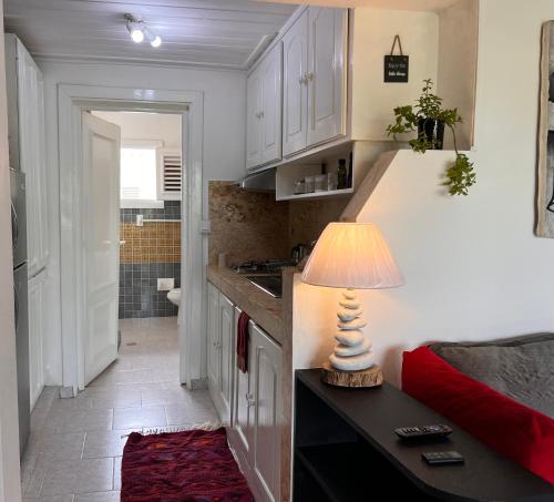 a kitchen with a table with a lamp on a counter at Cosy apartments las terrenas in Las Terrenas