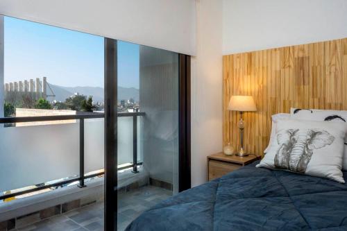 una camera con un letto e una grande finestra in vetro di Espacio Maipú a Salta