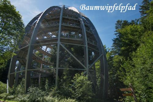 a glass dome in the middle of a garden at Helle FeWo am Waldrand - mit Balkon, Pool & Sauna in Freyung