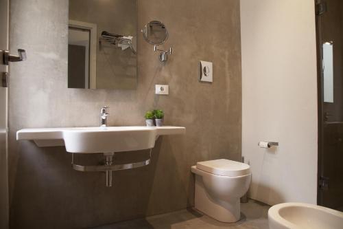 a bathroom with a sink and a toilet at Rosalmar B&B in Palermo