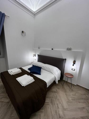 a bedroom with a large bed with towels on it at Dimora Dei Decumani in Naples