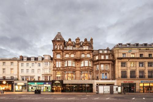 a large building with a clock tower on top of it at Hotel Indigo - Edinburgh - Princes Street by IHG in Edinburgh