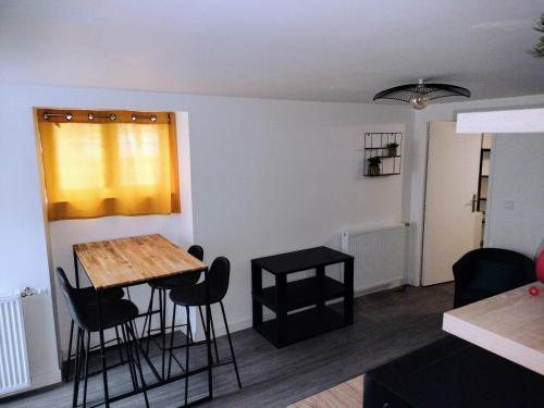 un salon avec une table et des chaises dans une pièce dans l'établissement Petite Maison Cosy en Baie, à Hillion