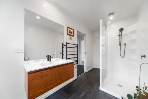 a bathroom with a sink and a shower at Mellow Yellow in Taupo