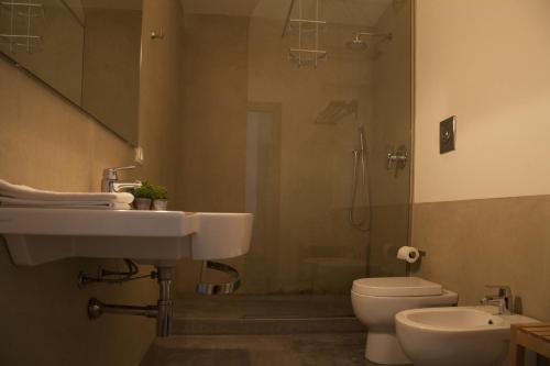 a bathroom with a sink and a toilet and a shower at Rosalmar B&B in Palermo