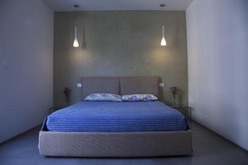 a bedroom with a large bed with two pillows at Rosalmar B&B in Palermo