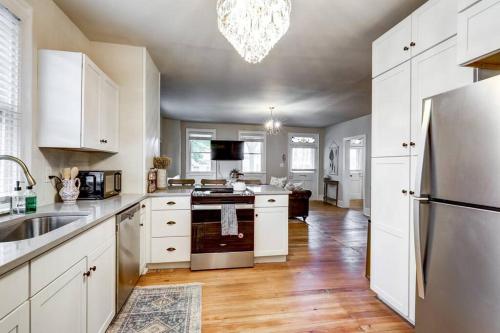 a kitchen with white cabinets and a stainless steel refrigerator at Victorian Manor on Main w 6 beds-10 mins to Lanc in Mountville
