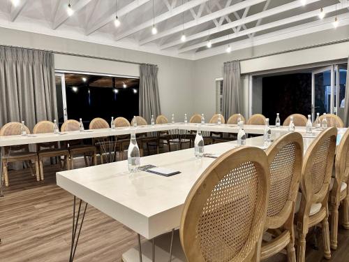 uma sala de conferências com uma mesa longa e cadeiras em Serene Place Guest House & Conference Venue AFFORDABLE LUXURY WITH BACKUP POWER em Roodepoort