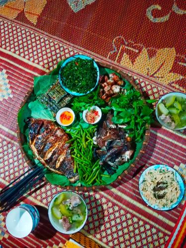 a plate of food with meat and vegetables on a table at homestay phô núi suôi giang in Yên Bái