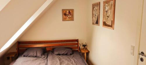a bedroom with a bed with two pillows on it at Stort værelse med lækkert badeværelse in Horsens