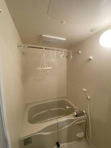 a bathroom with a bath tub in a room at リブレ in Kumamoto 201 in Kumamoto