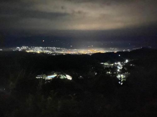a view of a city at night with lights at homestay phô núi suôi giang in Yên Bái