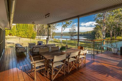 a large deck with a table and chairs on it at Tambo Lindo in Smiths Lake