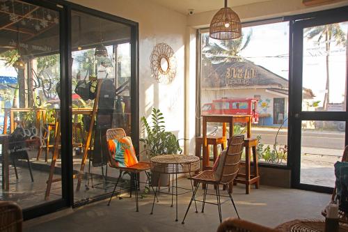 a restaurant with chairs and a table and a window at Sea View Resort in Siquijor