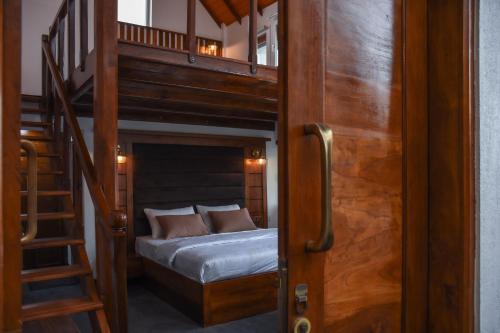a bedroom with a bunk bed and a staircase at JL Grand Hotel in Nuwara Eliya