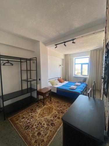 a bedroom with a bed and a bunk bed at Alma Villa Guest House - Bosteri in Bosteri