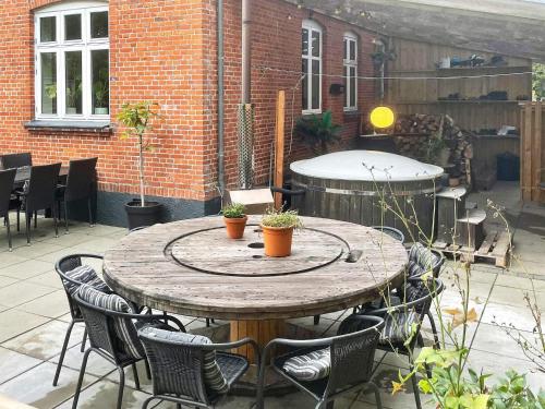 a wooden table with chairs on a patio at 5 star holiday home in Grindsted-By Traum in Grindsted
