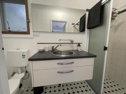 a small bathroom with a sink and a toilet at Self Contained Cabin in Nildottie