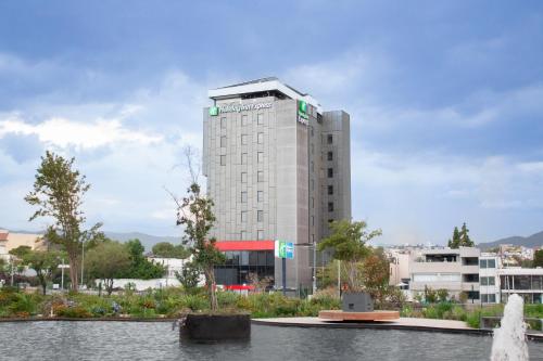 a tall building with a fountain in front of it at Holiday Inn Express Mexico City Satelite by IHG in Mexico City