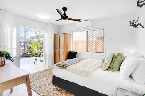 a bedroom with a bed and a ceiling fan at Tropical Terraces in Cairns