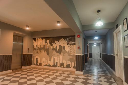 a hallway with a wall mural of a city at The Old Inn in Udon Thani
