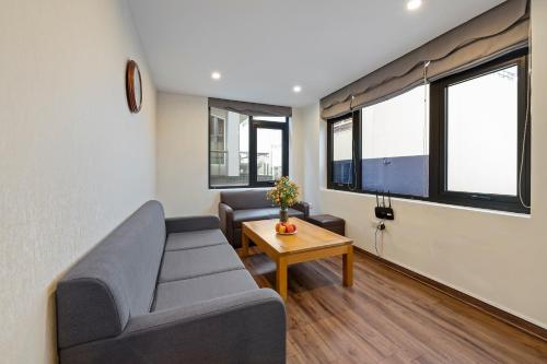 a living room with a couch and a table at 22Housing luxury Hotel & Residence 39 Linh Lang in Hanoi