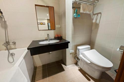 a bathroom with a toilet and a sink and a mirror at 22Housing luxury Hotel & Residence 39 Linh Lang in Hanoi