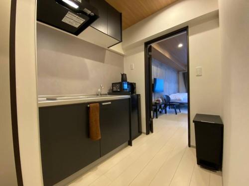 a kitchen with a sink and a counter top at リブレ in Kumamoto 301 in Kumamoto