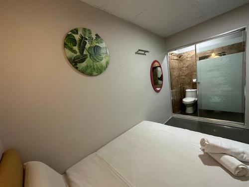 a bedroom with a bed and a mirror and a bathroom at DingDong Bukit Bintang Luxury Suites,3mi to PaVlion mall in Kuala Lumpur