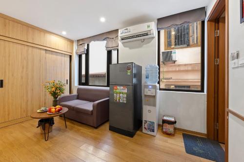 a living room with a refrigerator and a couch at 22Housing luxury Hotel & Residence 39 Linh Lang in Hanoi